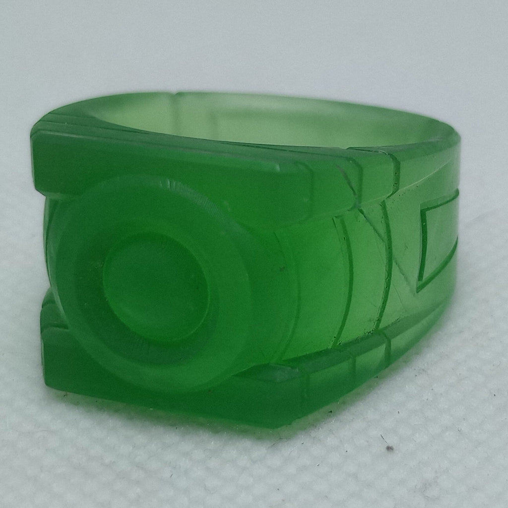 Green plastic ring with a logo on a white background