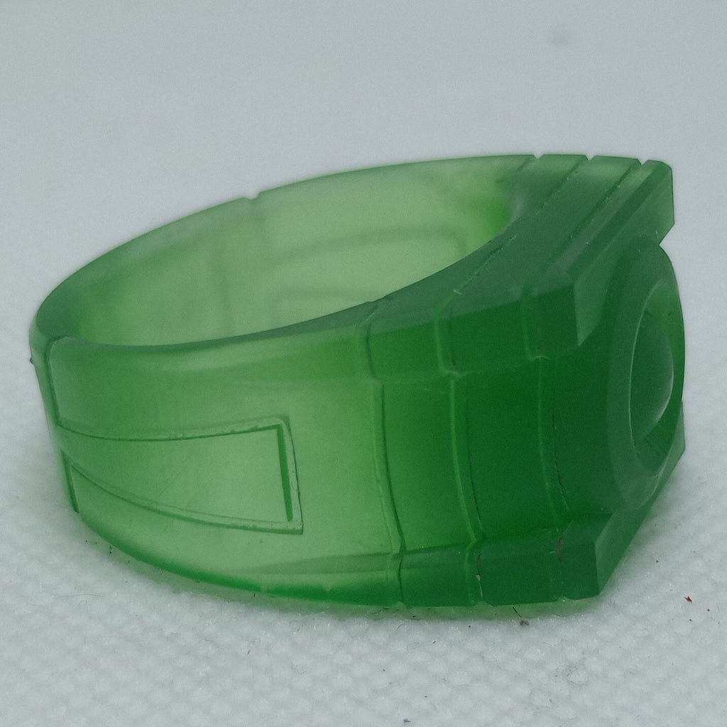 Green plastic ring on a textured white surface
